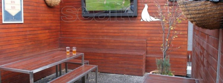 Outdoor Television Enclosure mounted to a wall in a pub